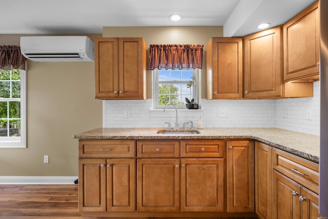 33 Pease Farm Rd, Ellington, CT 06029 - kitchen featuring a wall mounted air conditioner, wood finished floors, backsplash, and brown cabinetry
