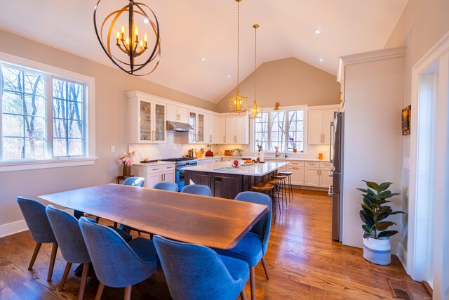 471 Newtown Tpke, Redding, CT 06896 - dining area with a chandelier, vaulted ceiling, and dark wood-style floors