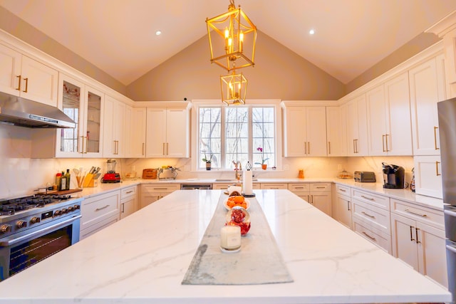 471 Newtown Tpke, Redding, CT 06896 - kitchen with under cabinet range hood, stainless steel appliances, a kitchen island, white cabinets, and high vaulted ceiling