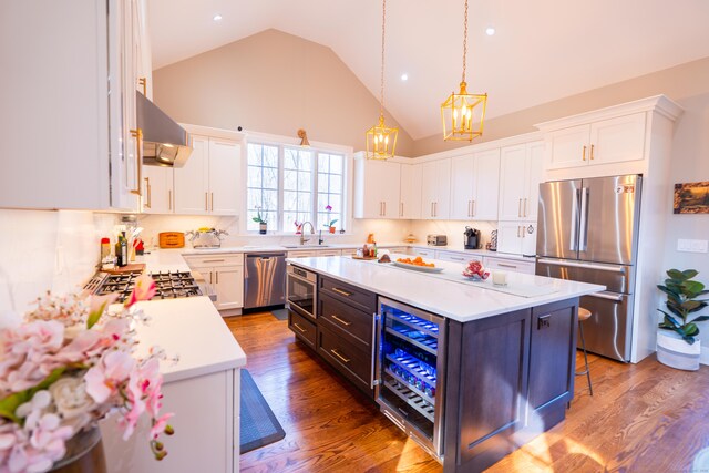 471 Newtown Tpke, Redding, CT 06896 - kitchen featuring stainless steel appliances, a chandelier, light countertops, high vaulted ceiling, and under cabinet range hood