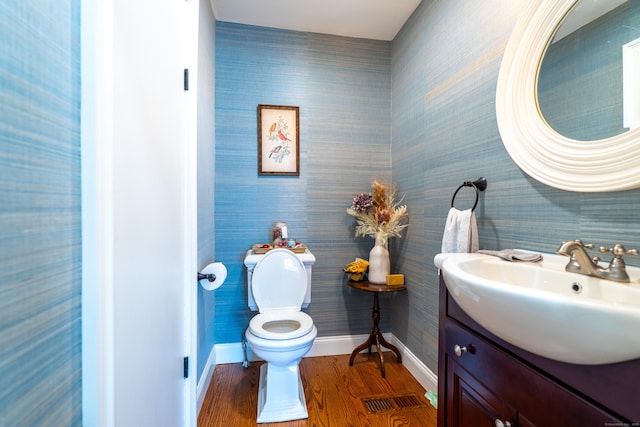471 Newtown Tpke, Redding, CT 06896 - half bath featuring baseboards, wood finished floors, toilet, vanity, and wallpapered walls