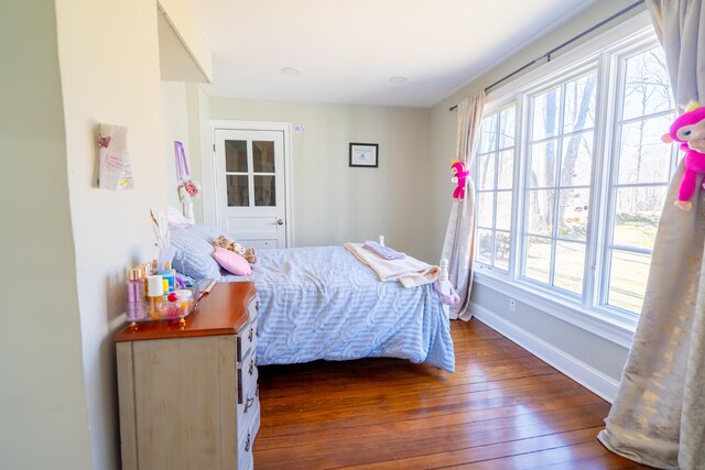 471 Newtown Tpke, Redding, CT 06896 - bedroom featuring wood-type flooring, multiple windows, and baseboards