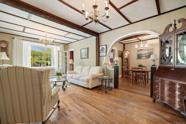 255 Killingly Rd, Pomfret, CT 06259 - living room featuring a chandelier, arched walkways, hardwood / wood-style floors, beam ceiling, and baseboards