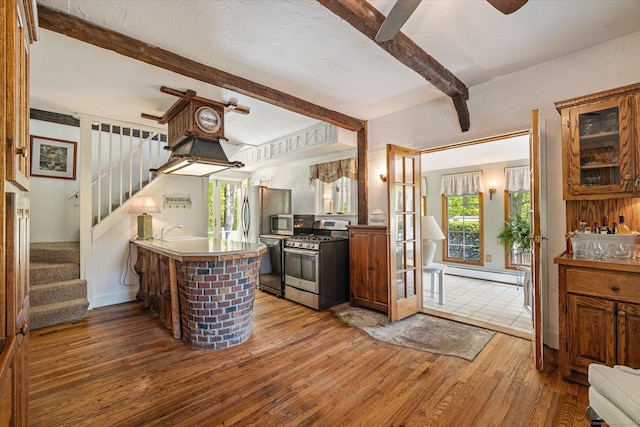 255 Killingly Rd, Pomfret, CT 06259 - kitchen with stainless steel appliances, a baseboard radiator, beamed ceiling, hardwood / wood-style floors, and a sink