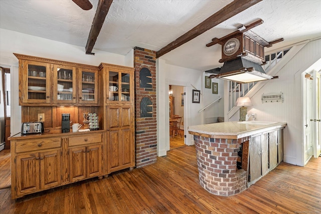 255 Killingly Rd, Pomfret, CT 06259 - kitchen featuring beamed ceiling, brown cabinetry, dark wood finished floors, glass insert cabinets, and a sink