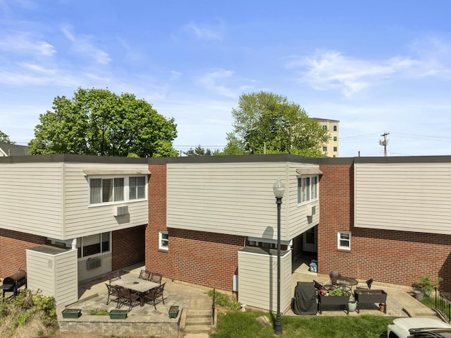 211 W Walk Unit 211, West Haven, CT 06516 - back of property with a patio area and brick siding