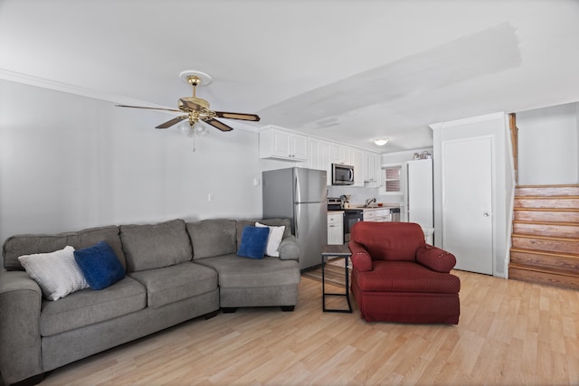 211 W Walk Unit 211, West Haven, CT 06516 - living room with stairway, light wood finished floors, ceiling fan, and ornamental molding