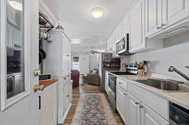 211 W Walk Unit 211, West Haven, CT 06516 - kitchen featuring appliances with stainless steel finishes, a sink, white cabinets, ceiling fan, and wood finished floors