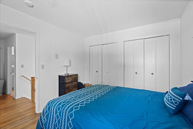 211 W Walk Unit 211, West Haven, CT 06516 - bedroom featuring wood finished floors, multiple closets, and baseboards