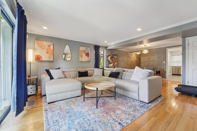 living area featuring ornamental molding, light wood-type flooring, recessed lighting, and baseboards