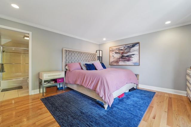 bedroom with ornamental molding, recessed lighting, baseboards, wood finished floors, and ensuite bath
