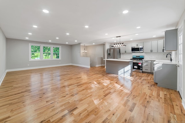 26 Maple Ave, North Haven, CT 06473 - kitchen with appliances with stainless steel finishes, gray cabinetry, a kitchen island, light countertops, and recessed lighting