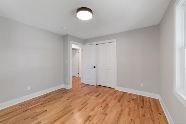 26 Maple Ave, North Haven, CT 06473 - unfurnished bedroom featuring baseboards, light wood finished floors, and a closet