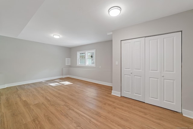 26 Maple Ave, North Haven, CT 06473 - unfurnished bedroom featuring light wood-type flooring, baseboards, and a closet