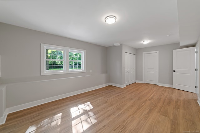 26 Maple Ave, North Haven, CT 06473 - unfurnished bedroom featuring light wood finished floors, baseboards, and a closet