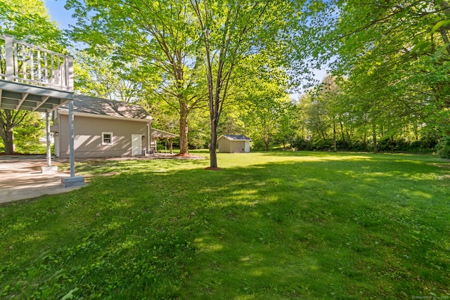 26 Maple Ave, North Haven, CT 06473 - view of grassy yard featuring a shed, an outbuilding, a patio, and view of scattered trees
