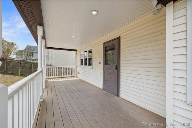 deck with covered porch and fence