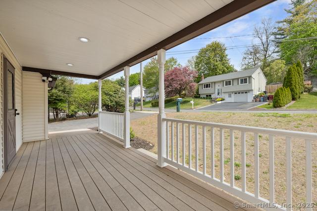 wooden deck with covered porch and a residential view