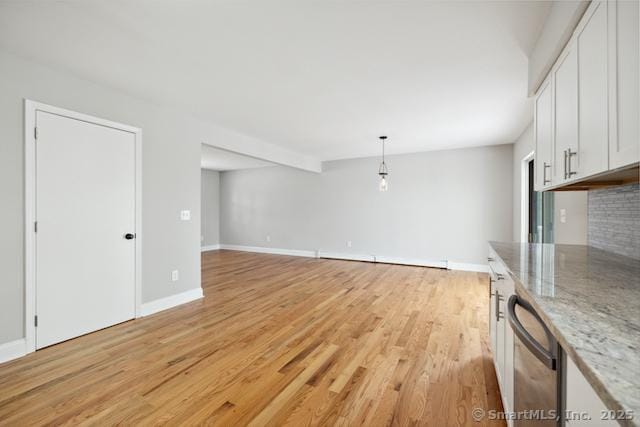 unfurnished living room featuring light wood-type flooring and baseboards