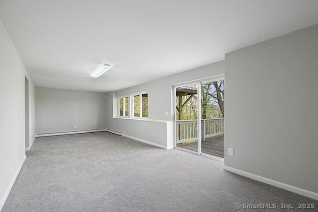 empty room with a baseboard radiator, baseboards, and carpet floors