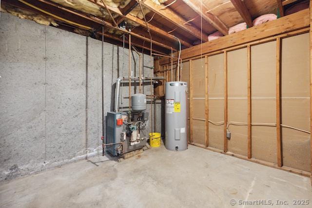 unfinished basement featuring electric water heater and a heating unit