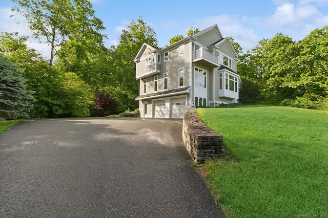 65 Church Rd, Sherman, CT 06784 - view of front facade with a balcony, driveway, a garage, and a front lawn