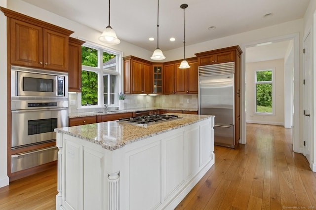65 Church Rd, Sherman, CT 06784 - kitchen featuring built in appliances, a warming drawer, light wood-type flooring, brown cabinetry, and a sink