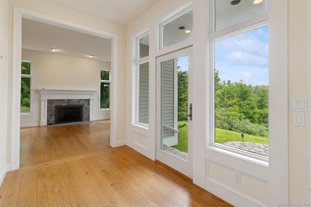 65 Church Rd, Sherman, CT 06784 - entryway featuring light wood-style flooring, a tile fireplace, healthy amount of natural light, and baseboards