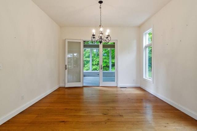 65 Church Rd, Sherman, CT 06784 - unfurnished dining area featuring a chandelier, baseboards, and wood finished floors