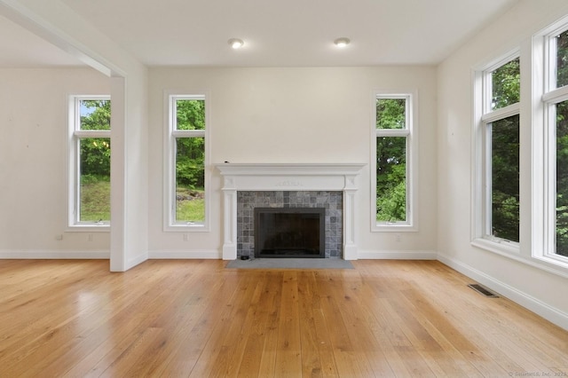 65 Church Rd, Sherman, CT 06784 - unfurnished living room with light wood-style floors, baseboards, and a tile fireplace