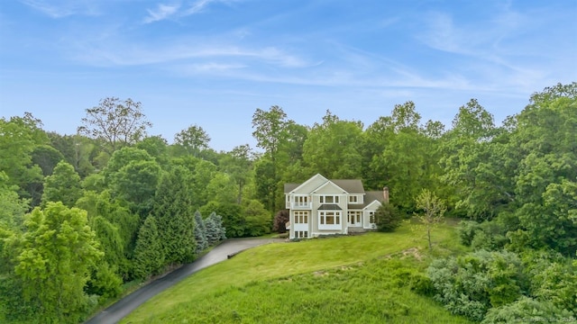 65 Church Rd, Sherman, CT 06784 - back of property with a lawn, a view of trees, covered porch, and driveway
