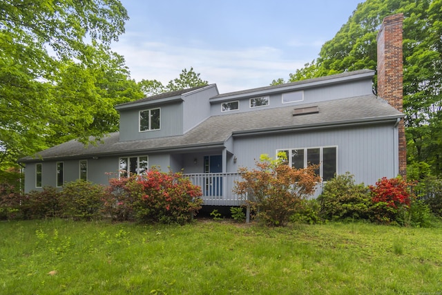 2 Meadowview Ln, Norwich, CT 06360 - back of house with a chimney, a yard, and a shingled roof