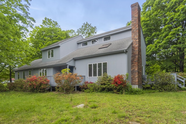 2 Meadowview Ln, Norwich, CT 06360 - rear view of house with a chimney, a shingled roof, a yard, and a wooden deck