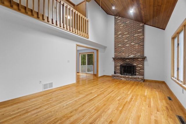 2 Meadowview Ln, Norwich, CT 06360 - unfurnished living room with high vaulted ceiling, wooden ceiling, wood finished floors, and a brick fireplace