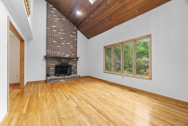 2 Meadowview Ln, Norwich, CT 06360 - unfurnished living room with hardwood / wood-style flooring, high vaulted ceiling, a skylight, wooden ceiling, and baseboards