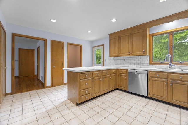 2 Meadowview Ln, Norwich, CT 06360 - kitchen featuring stainless steel dishwasher, a sink, a peninsula, light countertops, and tasteful backsplash