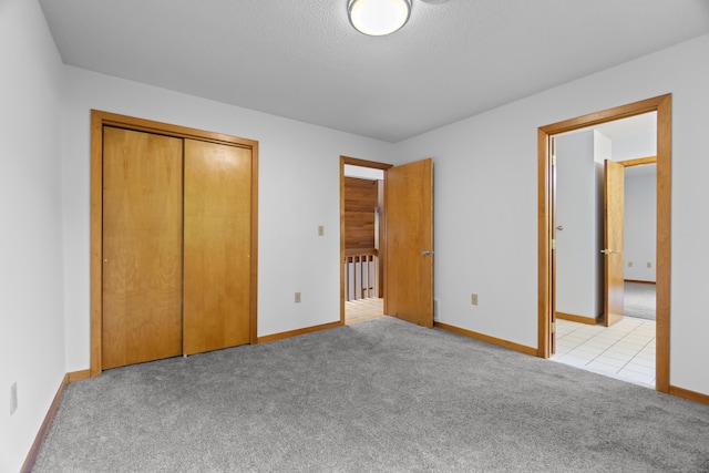 2 Meadowview Ln, Norwich, CT 06360 - unfurnished bedroom featuring light colored carpet, baseboards, and a closet