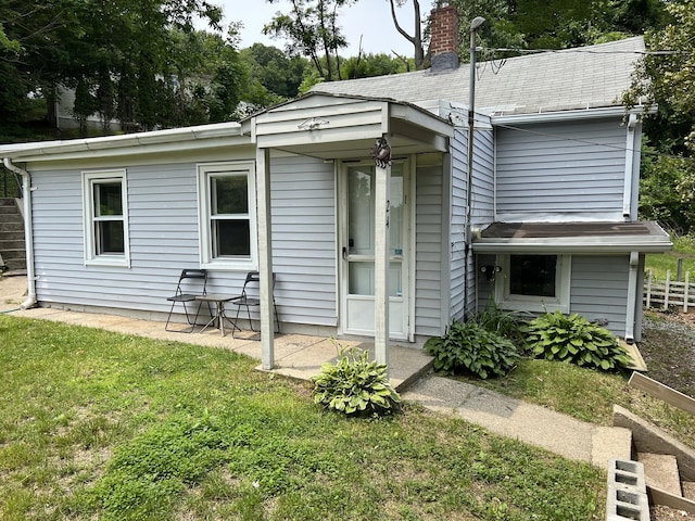 24 New St, Seymour, CT 06483 - back of house featuring a chimney and a patio