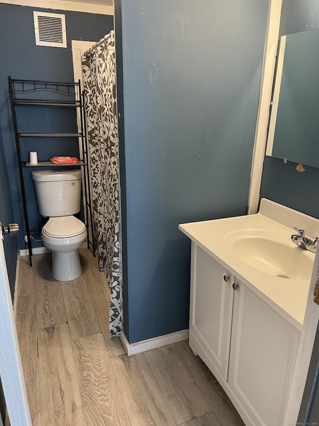 24 New St, Seymour, CT 06483 - bathroom featuring wood finished floors, toilet, vanity, and baseboards