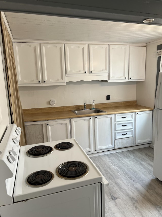 24 New St, Seymour, CT 06483 - kitchen with white appliances, a sink, and white cabinetry