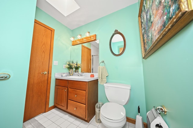 17A Morris Rd, Prospect, CT 06712 - bathroom with a skylight, toilet, vanity, tile patterned floors, and baseboards