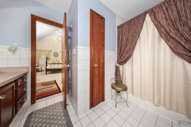 17A Morris Rd, Prospect, CT 06712 - ensuite bathroom featuring tile walls, tile patterned floors, a wainscoted wall, ceiling fan, and shower / bath combination with curtain