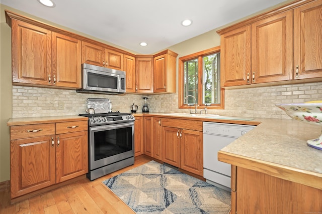 17A Morris Rd, Prospect, CT 06712 - kitchen with stainless steel appliances, a sink, light countertops, brown cabinetry, and recessed lighting