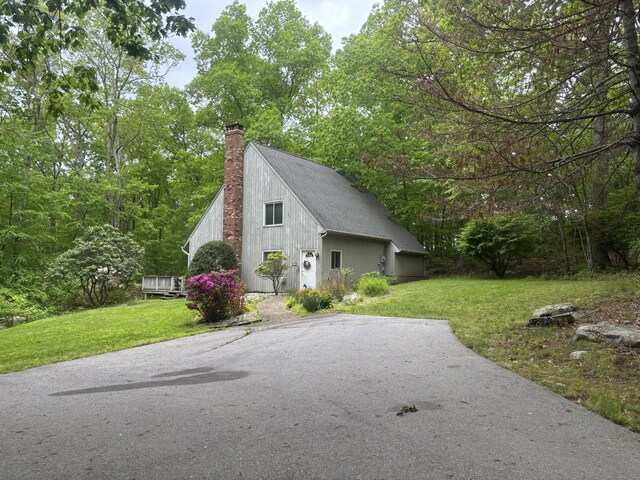 70 Lynn Rd, Essex, CT 06442 - view of side of home featuring a chimney and a yard