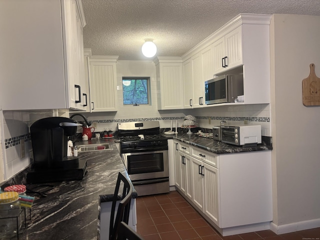 70 Lynn Rd, Essex, CT 06442 - kitchen featuring stainless steel appliances, tasteful backsplash, a textured ceiling, white cabinets, and a sink