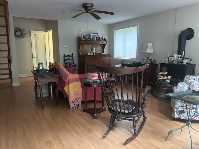 70 Lynn Rd, Essex, CT 06442 - dining area with light wood-type flooring, ceiling fan, and a wood stove