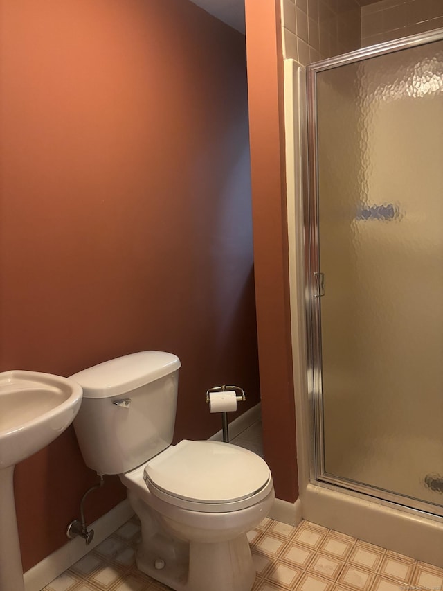 70 Lynn Rd, Essex, CT 06442 - full bathroom with a shower stall, tile patterned floors, toilet, and baseboards