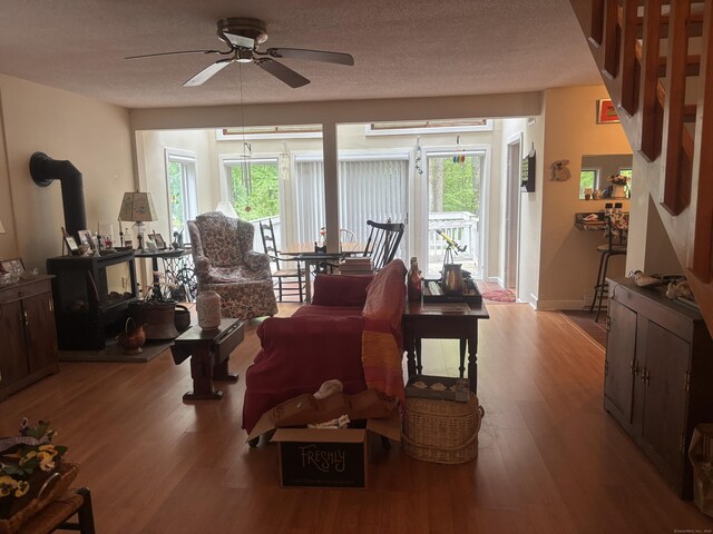 70 Lynn Rd, Essex, CT 06442 - living room featuring a ceiling fan, wood finished floors, and a wood stove