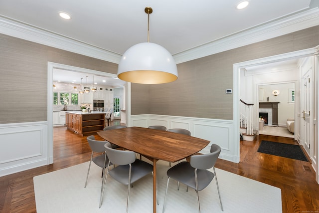 21 Park Pl, Darien, CT 06820 - dining area with ornamental molding, a fireplace, wainscoting, wallpapered walls, and recessed lighting