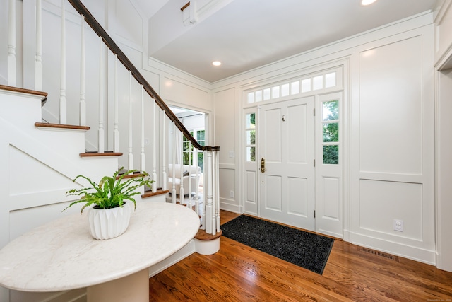 21 Park Pl, Darien, CT 06820 - entryway featuring a decorative wall, wood finished floors, stairs, recessed lighting, and crown molding